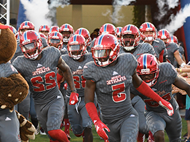 Football team coming out of the locker room in uniform before a game